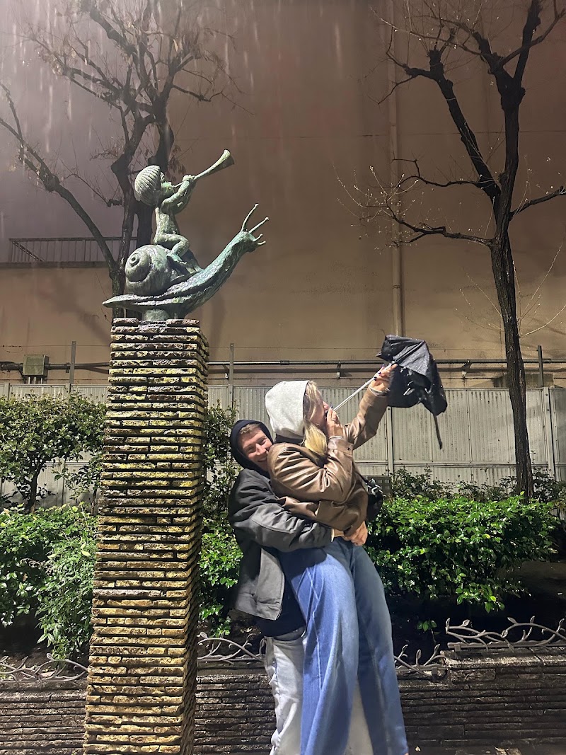 Statues of children riding fish and snail